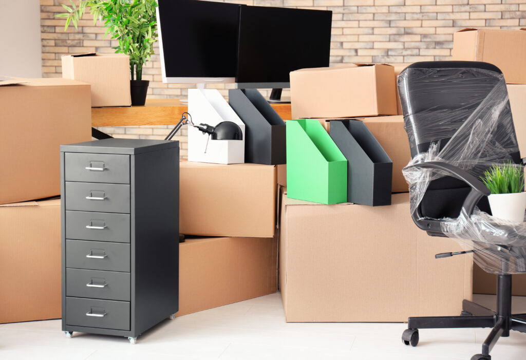 Carton boxes with stuff in empty room. Office move concept